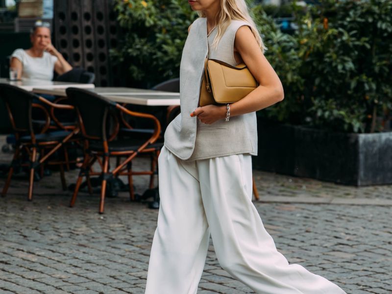 Elegant office style: shirt, light pants, pointed high heels